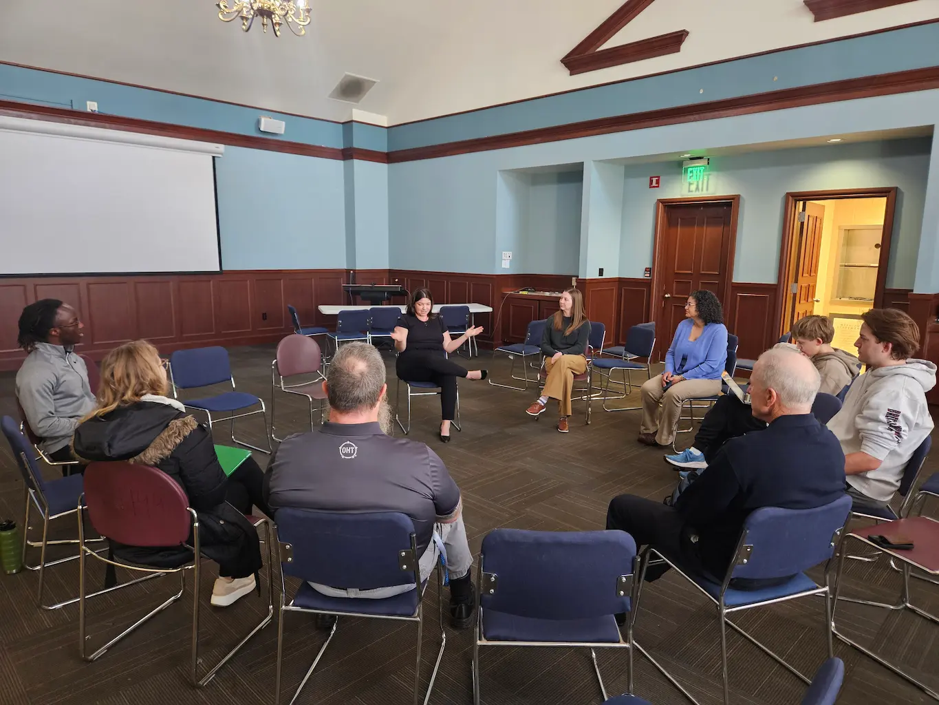 group of people sitting on chairs in a circle